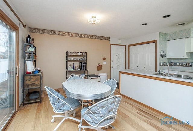 dining space with light wood-style flooring