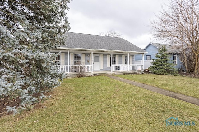 view of front of property with covered porch, a shingled roof, and a front lawn