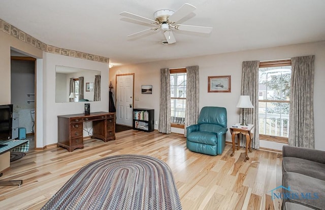 sitting room featuring light wood finished floors, ceiling fan, and a wealth of natural light