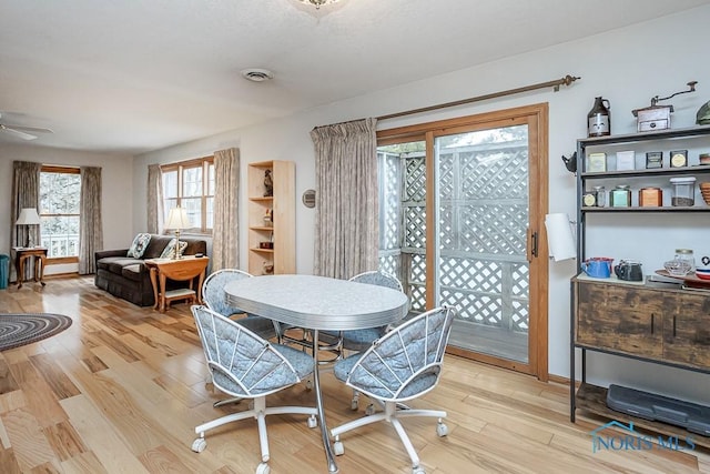 dining area featuring ceiling fan, visible vents, and wood finished floors