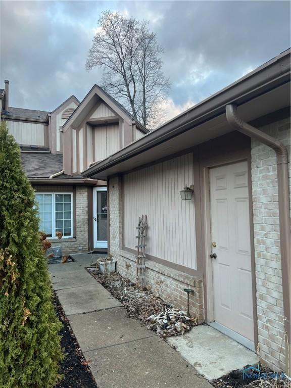 entrance to property featuring brick siding