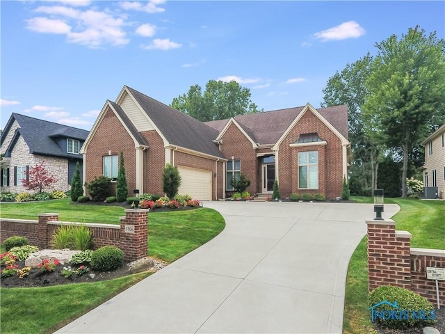 ranch-style home with brick siding, an attached garage, central AC unit, a front yard, and driveway