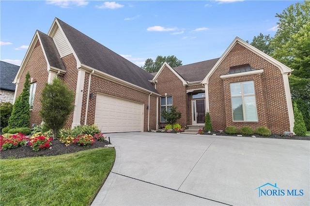 view of front facade with a garage, concrete driveway, and brick siding