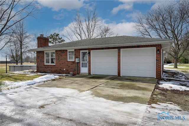 single story home with an attached garage, brick siding, concrete driveway, roof with shingles, and a chimney