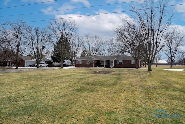 ranch-style house featuring brick siding and a front yard