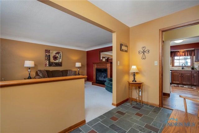 hallway featuring baseboards and crown molding