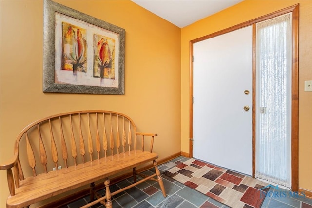 foyer entrance featuring baseboards