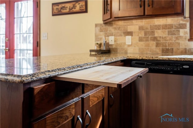 kitchen with decorative backsplash, light stone counters, stainless steel dishwasher, and a peninsula