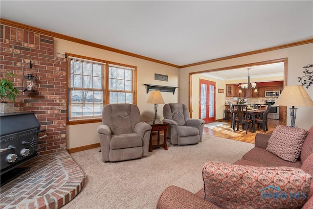 living room with ornamental molding, baseboards, and an inviting chandelier