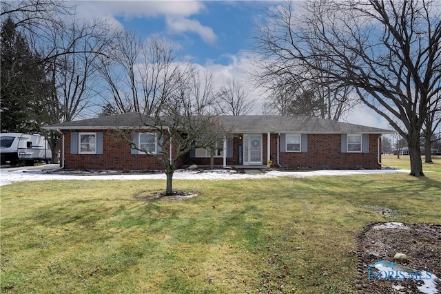 ranch-style home featuring crawl space, brick siding, and a front lawn