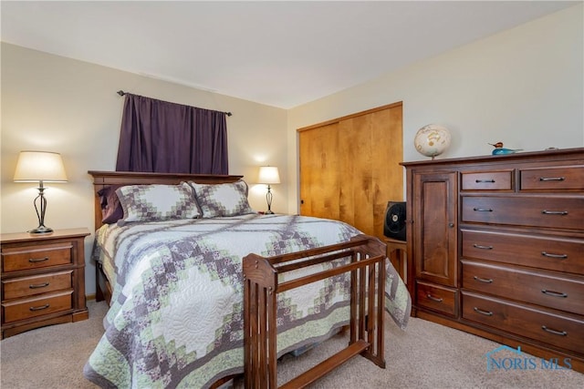 bedroom featuring light carpet and a closet