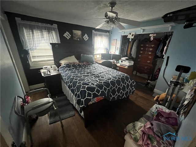 bedroom featuring wood finished floors and a ceiling fan