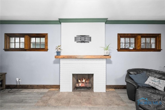 4526 Eastway St, Toledo, OH 43612 - living area with wood finished floors, a fireplace, baseboards, and ornamental molding