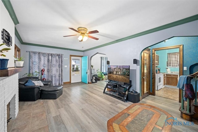 4526 Eastway St, Toledo, OH 43612 - living area with arched walkways, crown molding, a ceiling fan, and wood finished floors