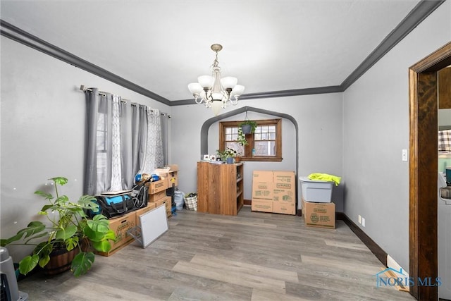4526 Eastway St, Toledo, OH 43612 - interior space with crown molding, baseboards, a chandelier, wood finished floors, and arched walkways
