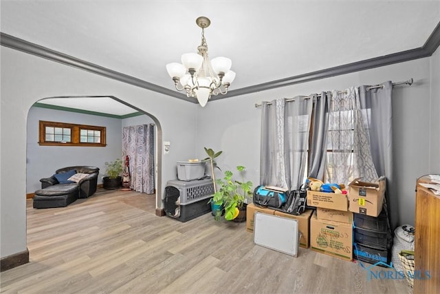 4526 Eastway St, Toledo, OH 43612 - rec room with arched walkways, a notable chandelier, wood finished floors, and ornamental molding