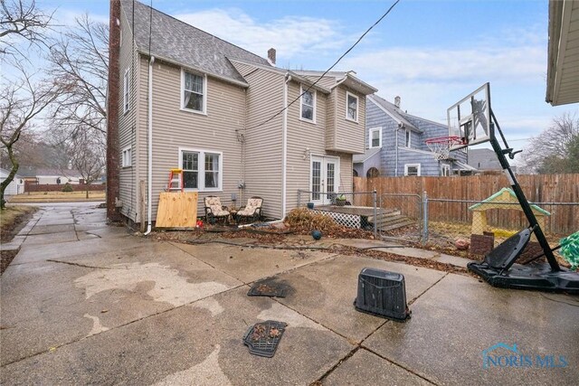 4526 Eastway St, Toledo, OH 43612 - rear view of house with a patio, fence, roof with shingles, a chimney, and french doors