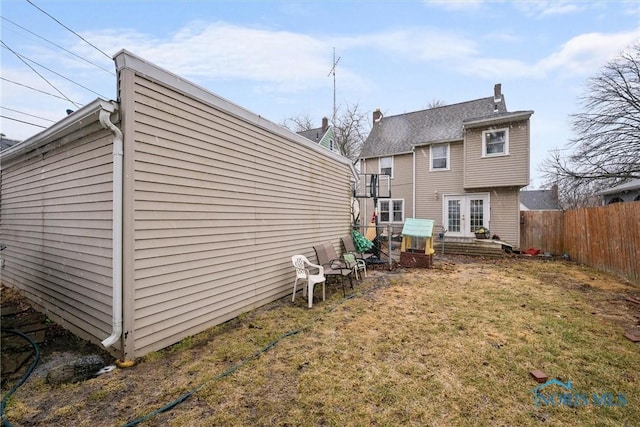 4526 Eastway St, Toledo, OH 43612 - back of house with french doors, a lawn, and fence