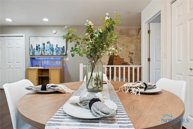 dining area featuring wood finished floors and recessed lighting