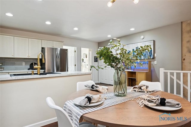 dining space with baseboards and recessed lighting