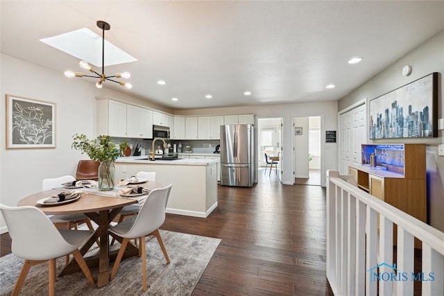 dining area featuring a chandelier, recessed lighting, dark wood finished floors, and baseboards