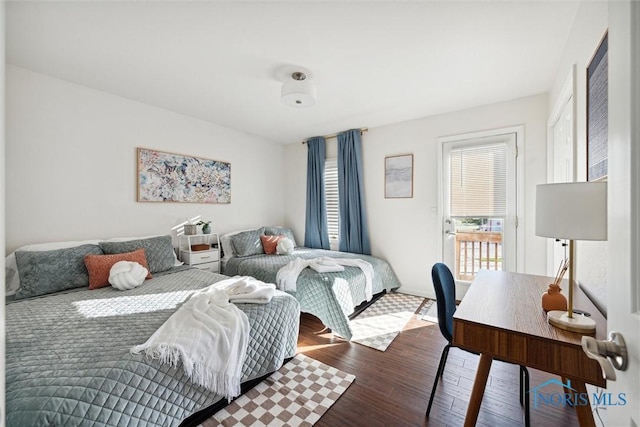 bedroom featuring multiple windows and wood finished floors