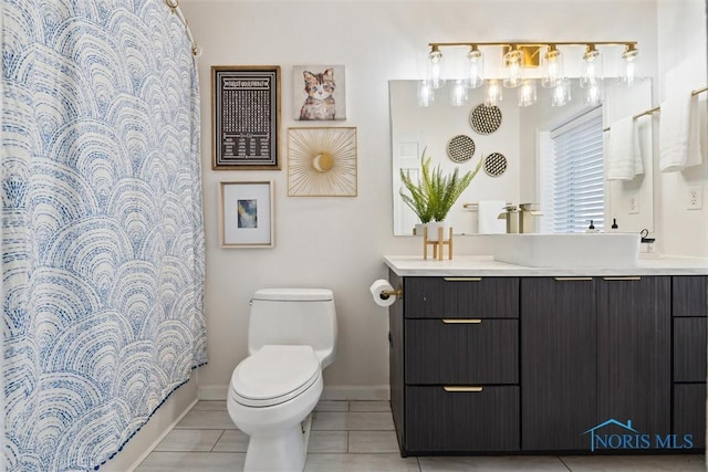 full bathroom featuring baseboards, vanity, toilet, and tile patterned floors