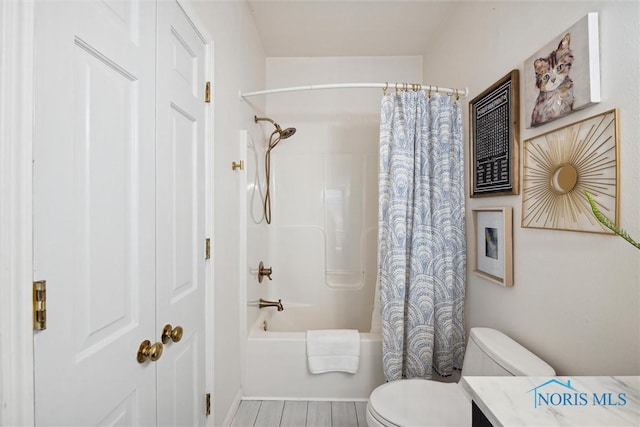 bathroom with toilet, shower / bath combo with shower curtain, and vanity