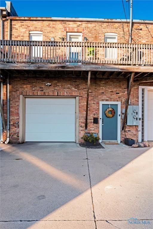 view of front of house with concrete driveway and brick siding