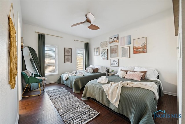 bedroom featuring ceiling fan, hardwood / wood-style floors, and baseboards