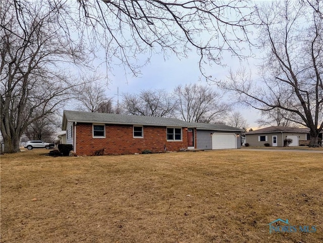 single story home with a garage, brick siding, and a front lawn