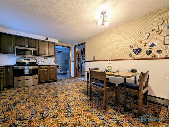 kitchen featuring stainless steel appliances, light countertops, dark brown cabinetry, and a textured ceiling