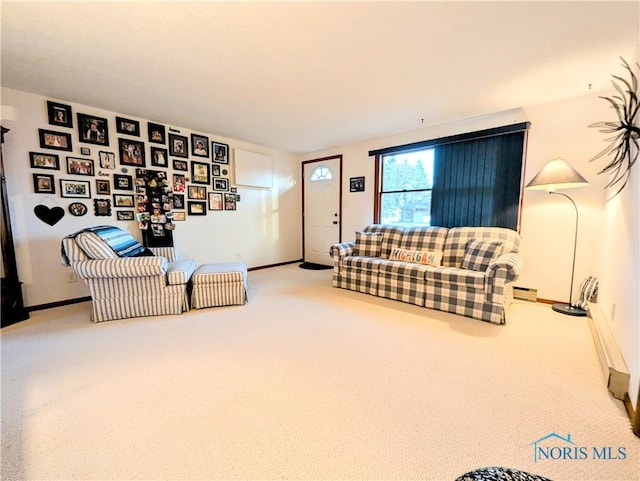 living room featuring carpet, a baseboard heating unit, and baseboards