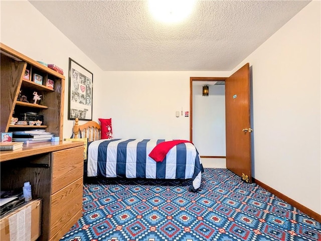 carpeted bedroom with a textured ceiling and baseboards