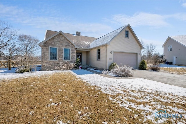 view of front of property with driveway, stone siding, a garage, and a chimney