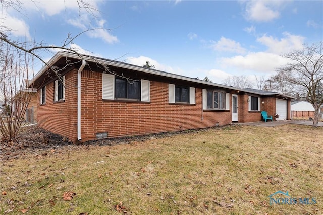 view of home's exterior with a garage, brick siding, a lawn, and driveway