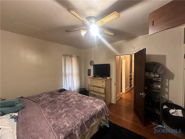 bedroom featuring a ceiling fan and dark wood-style flooring