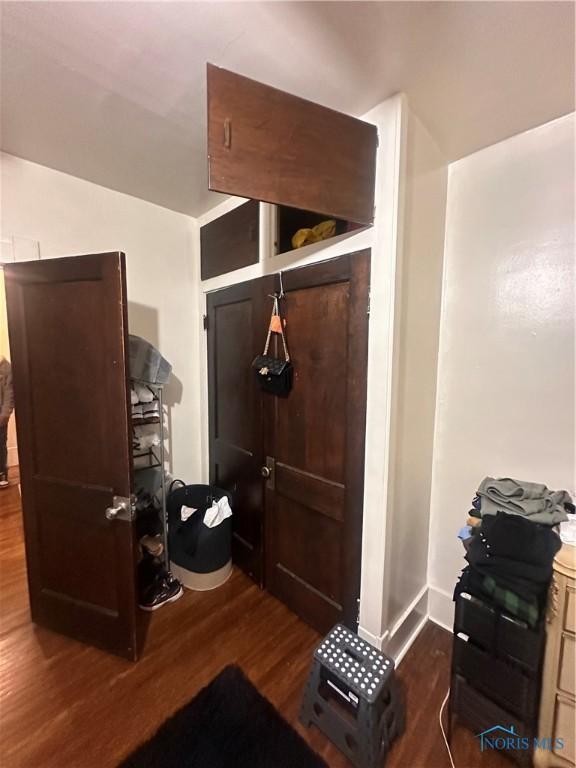 interior space with baseboards and dark wood finished floors