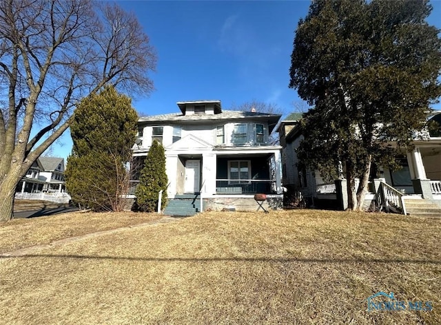 traditional style home with a porch and a front yard