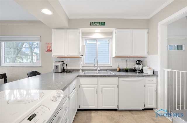 kitchen with range with electric stovetop, backsplash, white cabinets, white dishwasher, and a sink