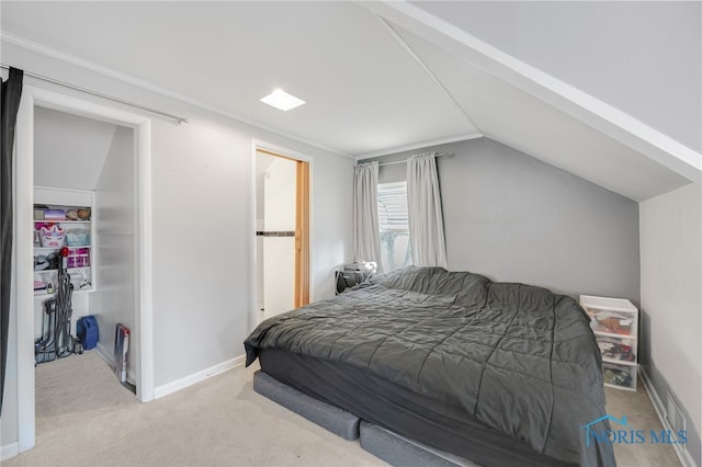 bedroom with carpet, baseboards, and vaulted ceiling