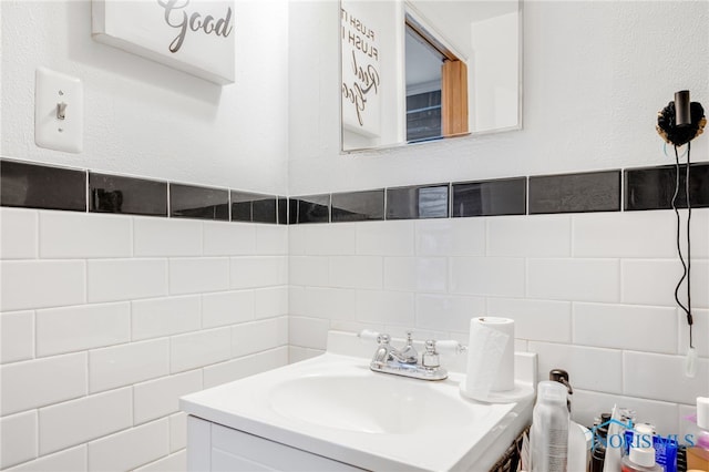 bathroom featuring tile walls and vanity