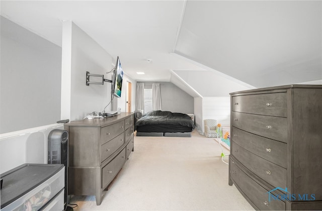 bedroom with light carpet and lofted ceiling