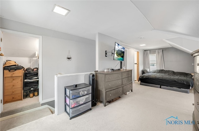 carpeted bedroom with lofted ceiling