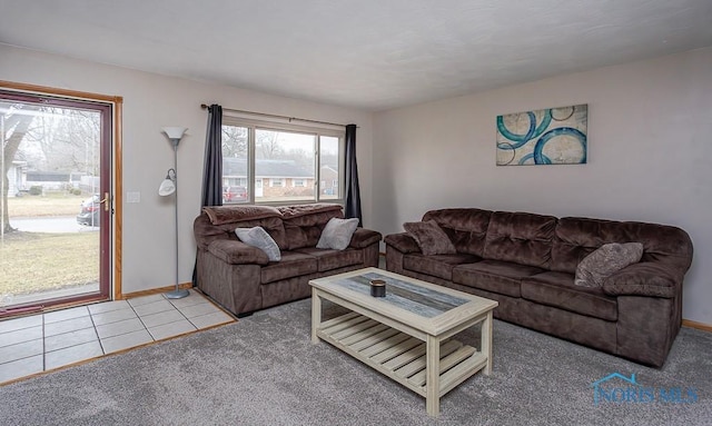 carpeted living room featuring tile patterned flooring and baseboards