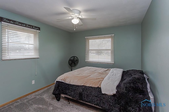 carpeted bedroom featuring a ceiling fan and baseboards