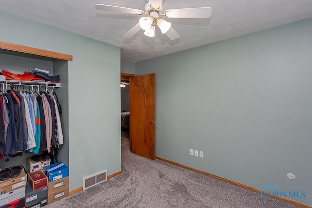 bedroom featuring baseboards, visible vents, a ceiling fan, carpet, and a closet