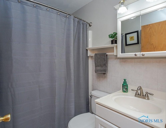 full bath featuring toilet, a shower with curtain, tile walls, and vanity