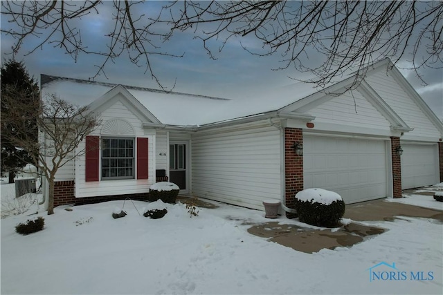 ranch-style house with an attached garage and brick siding