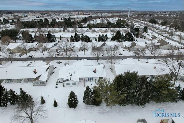 snowy aerial view with a residential view